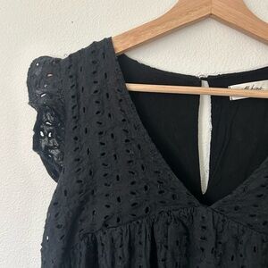 Black eyelet mini dress with ruffle detail and pockets!
